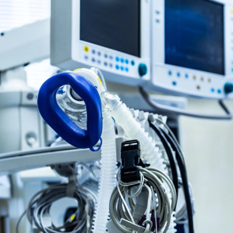 Medical oxygen mask with medical screens in the background
